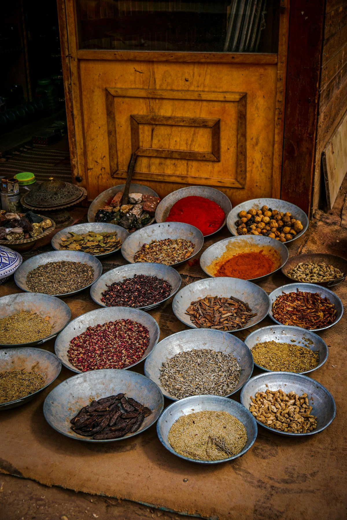 Glass jars of colorful spices arranged on a shelf